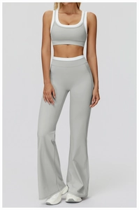 Detail view of high waist yoga set with flared pants and layered sports bra in light grey