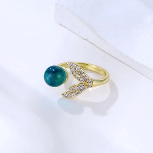 Golden mermaid tail open ring with blue crystal ball and sparkling zircon details