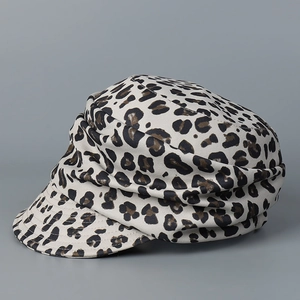 Detail view of the leopard print newsboy cap with stylish pleated design and curved brim