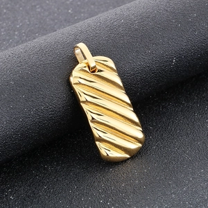 Macro view of gold rectangular bar pendant with ripple texture on dark background
