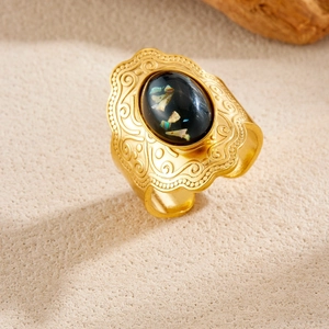 Vintage gold wide band ring with oval black stone and intricate floral engraving