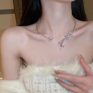 Silver collar necklace with zircon butterfly and tassel on female model neck