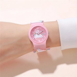 Close-up of pink children's watch featuring a cute unicorn and rainbow dial illustration