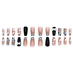 Long coffin fake nails with cow print, white bows, and pearls in 24 piece set