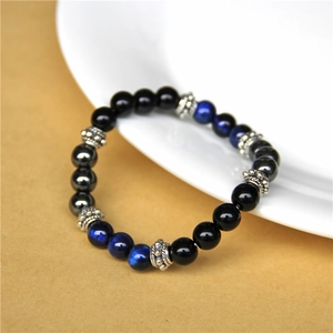 Detail of natural tiger eye stone bracelet with blue and black beads and silver spacers