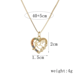 Detail showing gold MOM heart pendant dimensions 1.5x2cm with colorful zircon stones