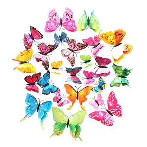 Flat lay of colorful 3D butterfly wall stickers in various sizes on white background