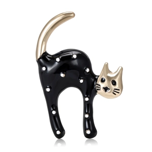 Cute black and white spotted cat enamel brooch pin with gold metal details on white background