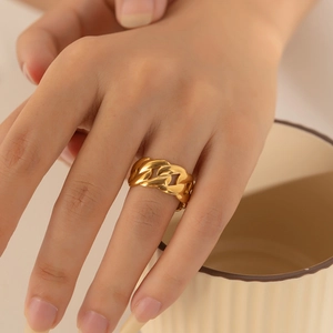 Close-up of golden chain design adjustable ring worn on a finger for detail display