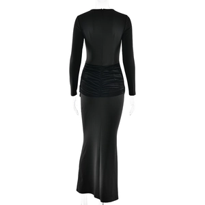 Detail view of the elegant ruched back waist design on a black long sleeve floor-length gown