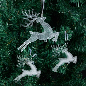 Three transparent acrylic reindeer ornaments hanging on a Christmas tree with white strings