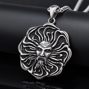 Macro detail of Nordic sun god pendant in vintage silver steel on black backdrop