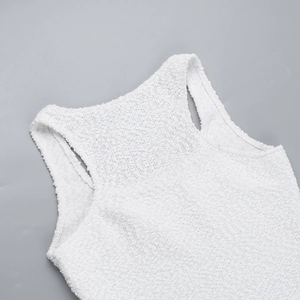 Detailed macro view of the white boucle textured vest neckline and soft shoulder fabric