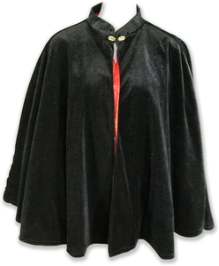 Short black velvet Christmas cape with red lining and golden buckle on white background