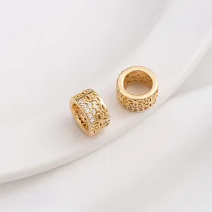 Macro view of 14K gold plated hollow floral spacer beads with sparkling zircon inlay
