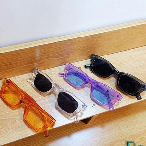 Top view of retro small frame sunglasses in orange, clear, purple and black colors