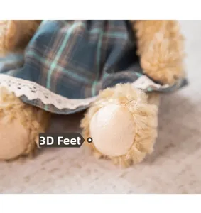 Detailed macro view of 3D stuffed feet on a teddy bear with lace plaid dress trim
