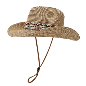 Bohemian wide brim straw sun hat with ethnic band and seashell beach decorations