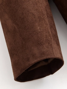 Close-up of the dark brown suede texture and stitching on the classic blazer cuff