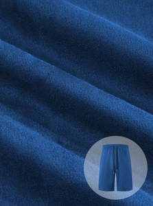Detail of blue knitted sports shorts featuring a drawstring waist and soft fabric texture