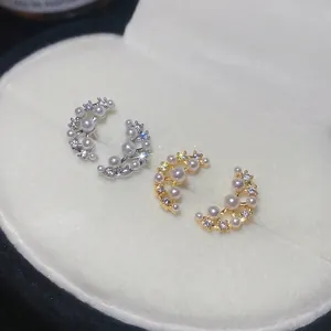 Elegant gold and silver crescent moon earrings with pearls and cubic zirconia