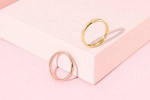 Detail of gold and rose gold stainless steel rings with frosted sand and polished finish