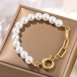Close-up of Baroque pearl bracelet with gold chain on elegant jewelry box