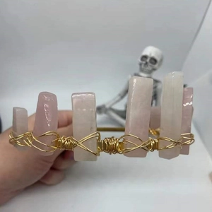 Detailed close-up of handmade rose quartz crystal crown secured with gold wire wrapping