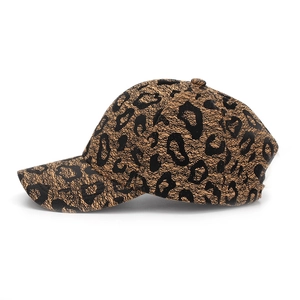 Side view of leopard print baseball cap with curved brim and textured leather finish