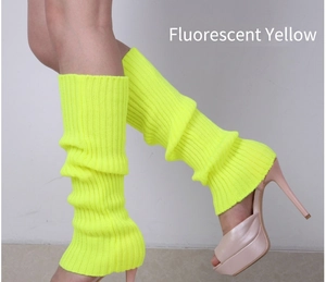 Close-up of fluorescent yellow ribbed knit leg warmers styled with high heel sandals