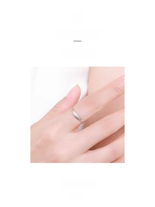 Detailed close-up of a delicate S925 sterling silver feather ring on a model hand