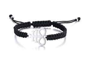 Detailed shot of black woven bracelet with silver Leviathan cross key and infinity charm