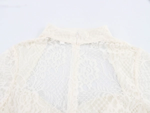 Close-up of the elegant lace texture and back invisible zipper on the high neck dress