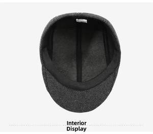Detail view of the breathable grey lining and cotton label inside the herringbone flat cap