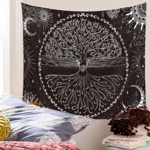 Detail of bohemian tree of life tapestry with sun and moon patterns on bedroom wall
