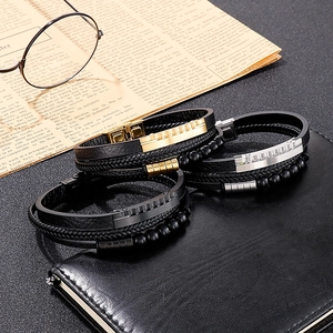 Close-up of leather woven bracelets with stainless steel beads on a vintage book