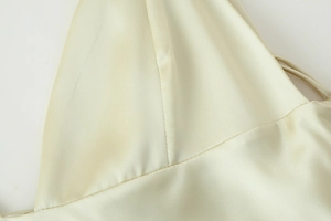 Detail of satin fabric texture and premium stitching on champagne dress collar
