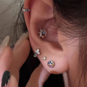 925 sterling silver cross earrings set with colorful zircon stones on model ear