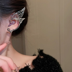 Detail of silver butterfly wing ear cuff on model with minimalist polished finish