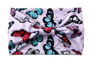 Detail of light purple wide headband featuring colorful butterfly patterns and center knot