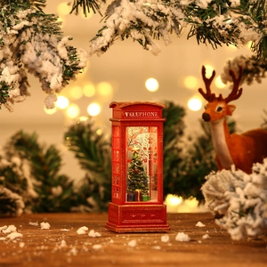 Macro detail of red Christmas telephone booth lantern with glowing tree and festive decor