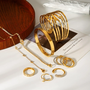 Luxury gold stainless steel jewelry set featuring heart zircon bracelets and rings