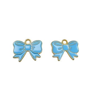 Detailed view of sky blue enamel bow pendant with gold metallic edges for jewelry making