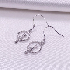 Elegant S925 sterling silver hollow cat earrings on white silk fabric background