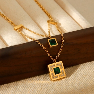 Double-layered gold titanium necklace with emerald square pendants and zircon accents