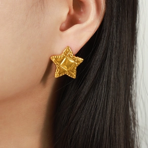 Chics boucles d'oreilles étoile plaquées or 18k avec texture matelassée sur un mannequin