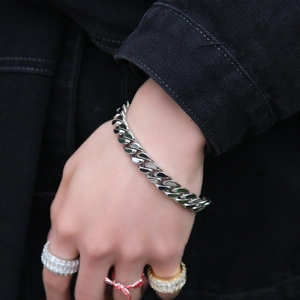 Classic silver Cuban link bracelet for men with spring clasp shown on male wrist