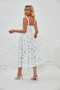 Detail view of floral midi sun dress showing the side slit and green flower pattern