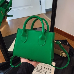 Minimalist green retro crossbody bag with gold hardware and adjustable shoulder strap