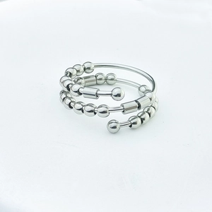 Macro detail of silver fidget ring with adjustable triple layers and movable beads